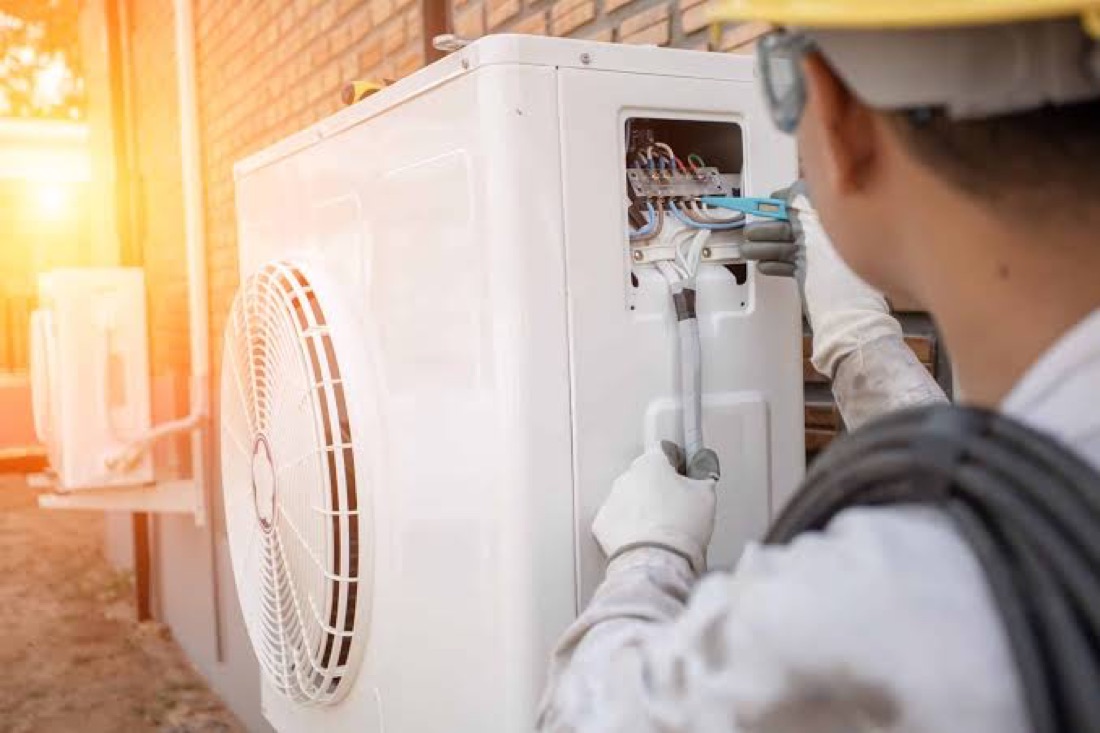 Meridian HVAC technician servicing a rooftop unit in Toronto ON